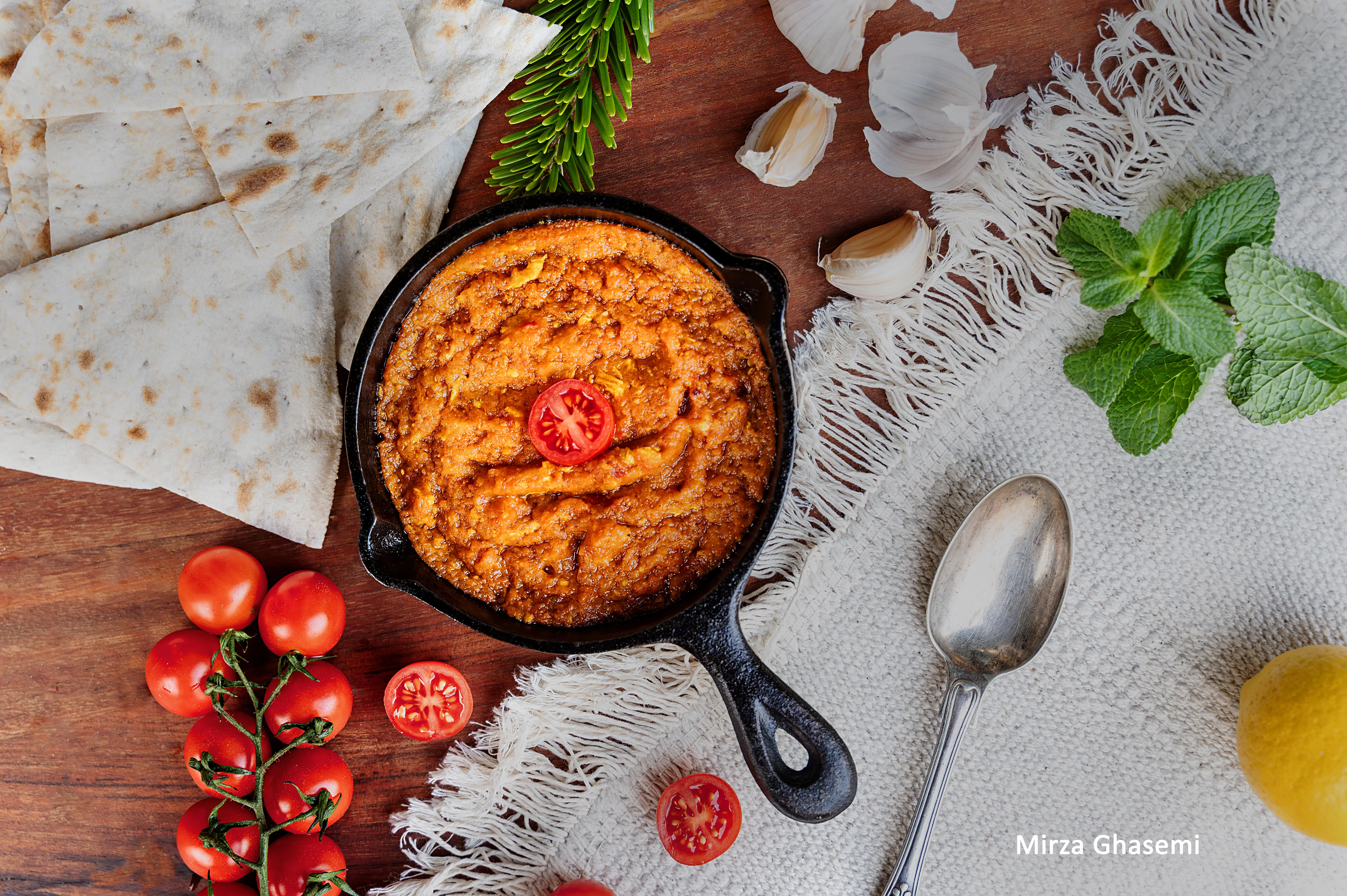 Traditional Persian Mirza Ghasemi served at Sams Master Grill, a smoky eggplant dish with garlic and tomatoes.